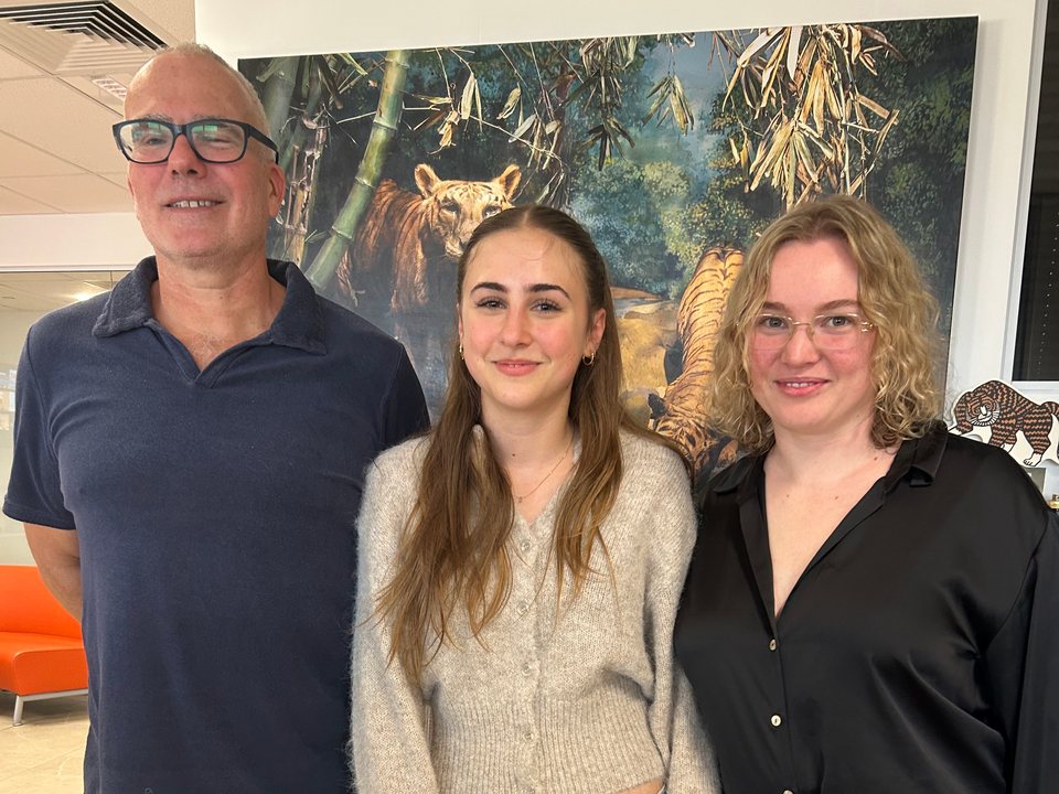 Stella with two Easy Tiger production team members in front of a tiger mural