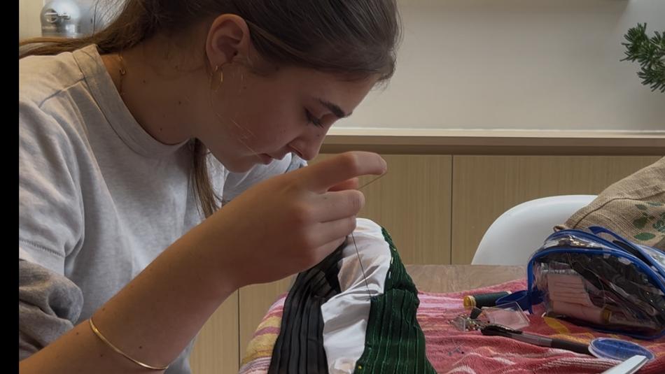 Stella at the sewing machine making costumes