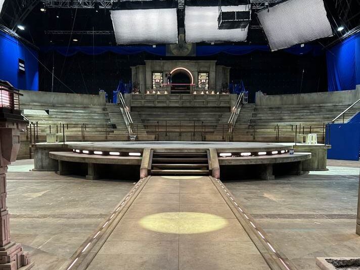 A blue-lit set with a single spotlight from the ceiling on the Street Fighter production