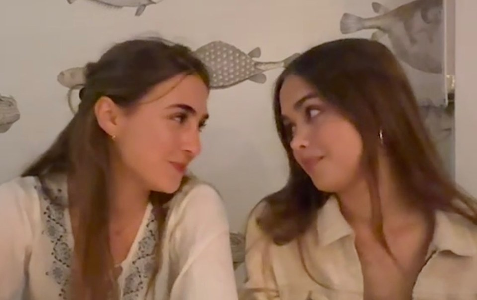 Two friends at a restaurant table looking at each other